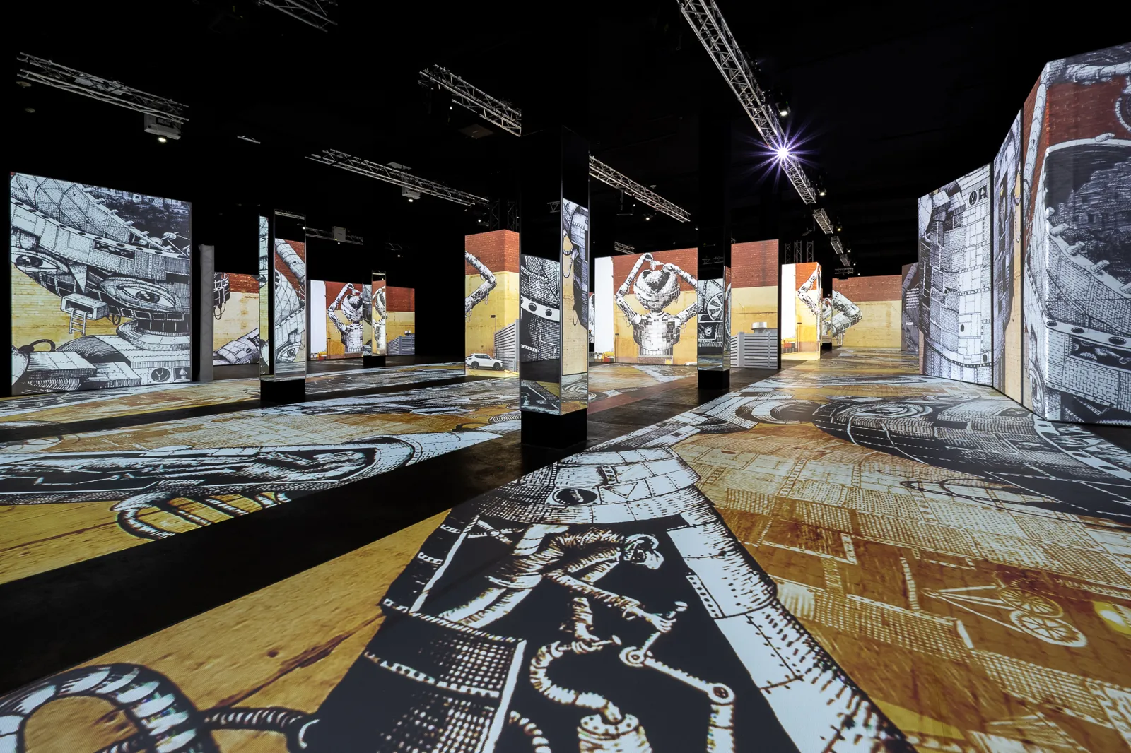 Black and white projected drawings covering the walls and floor of a hall