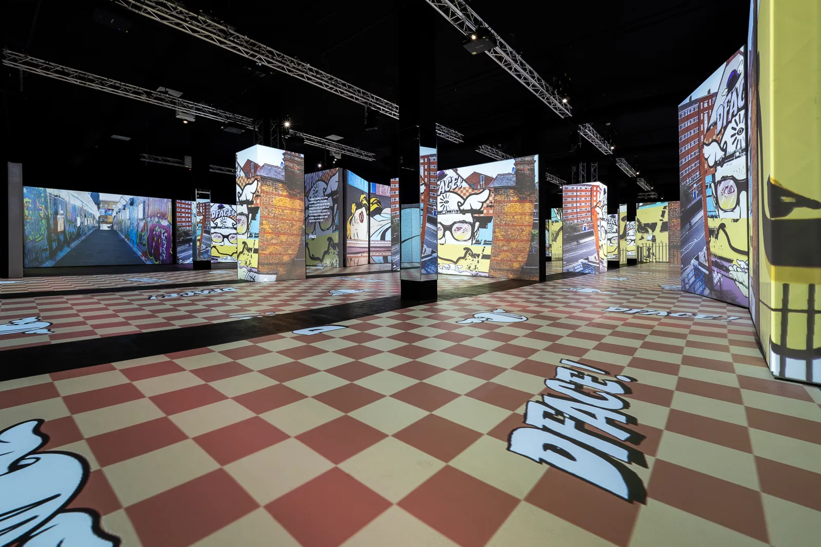 Comic style projections on tall panels above a red and cream checkered floor