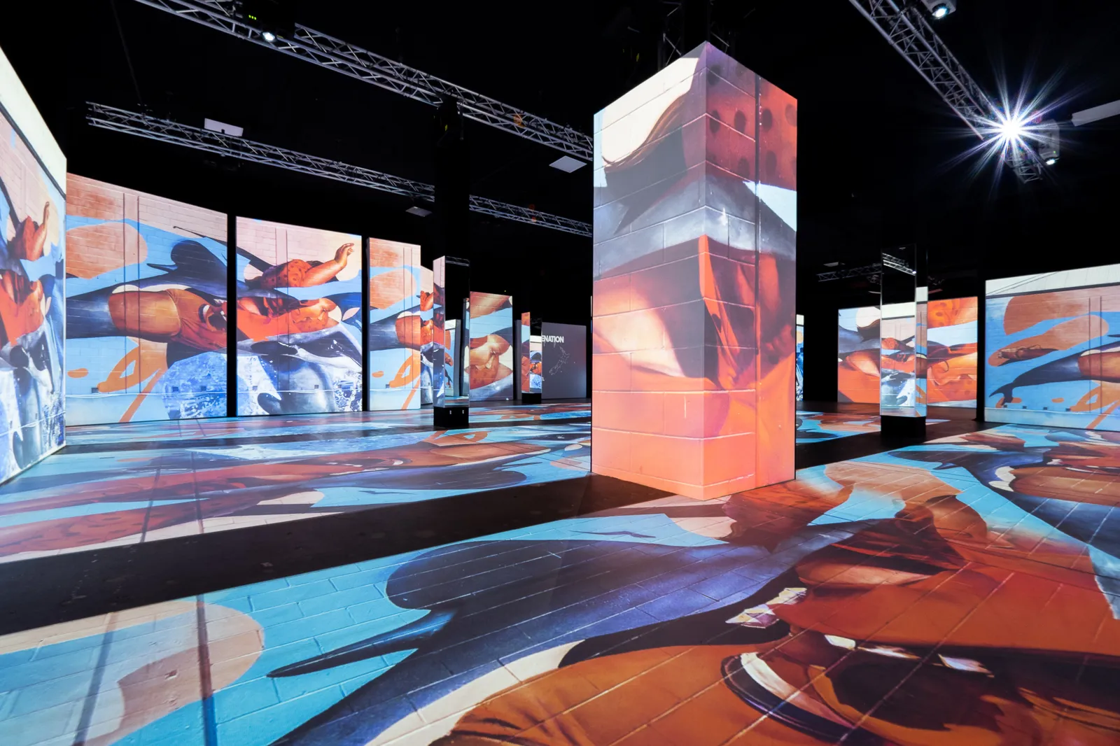 A tall projected column stands at the center of an empty art hall
