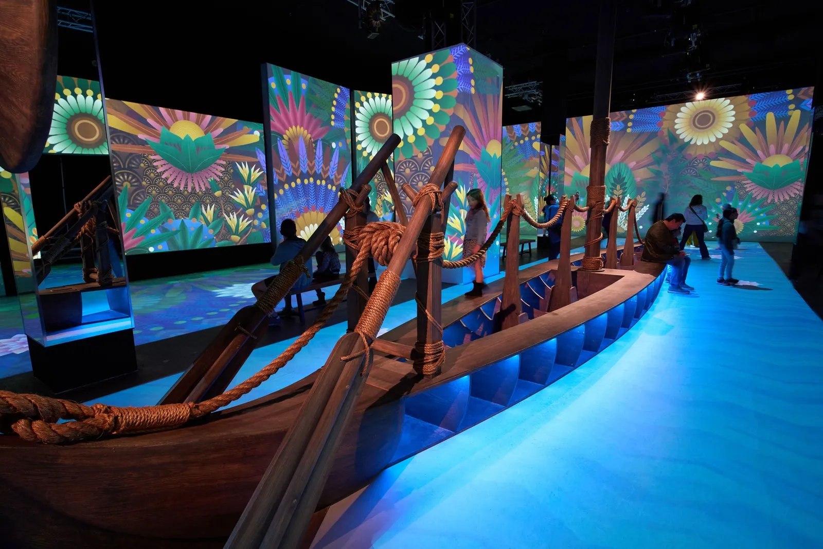 Guests walking through a projection-mapped exhibition hall at Magic Box Event Campus